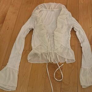 White cute top with fringe on bottom and sleeves. Worn 1x. Perfect condition.